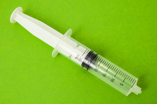Big Black and White Syringe on a Colored Background