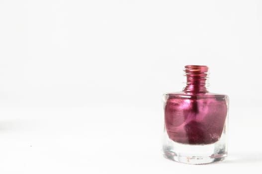 Colorful nail polish brush over white background