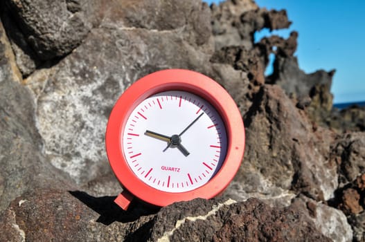 Time Concept Alarm Clock on the Volcanic Rocks