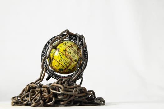 Earth globe close in chain and padlock