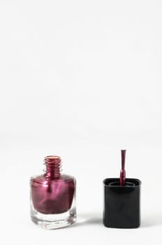 Colorful nail polish brush over white background