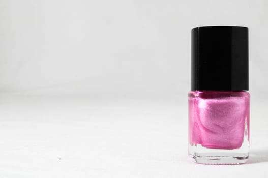 Colorful nail polish brush over white background