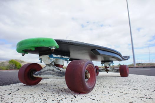Vintage Style Longboard Black Skateboard on an Empty Asphalt Desert Road