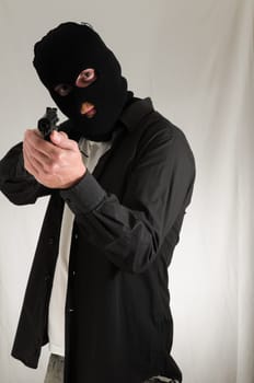 Black Dressed Young Man Holding a Pistol Gun