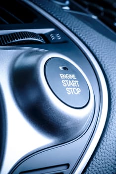 start / stop button ignition in the car,the vehicle with visible portion of the instrument panel in the vehicle interior.