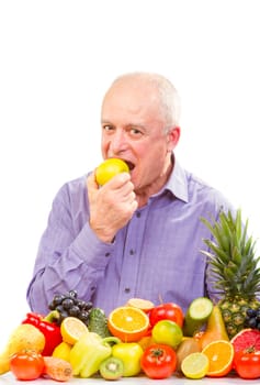 Closeup of senior man eating a green apple against white background