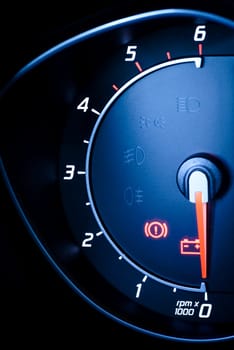 photo presents the car's vehicle's speedometer or tachometer with visible information display - ignition warning lamp and brake system warning lamp,visible symbols of the instrument cluster (this check warning light),with warning lamps illuminated.