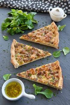 Rustic slate with quiche Lorraine and lamb's lettuce