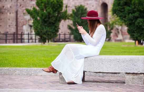 Girl in white with smartphone