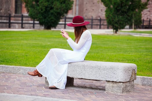 Girl in white with smartphone