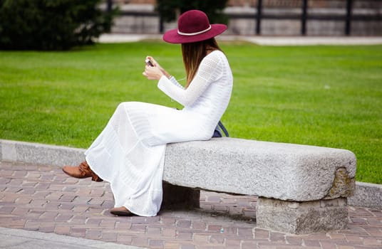 Girl in white with smartphone