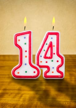 Burning birthday candles number 14
