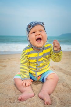 Cute baby sitting on a sand