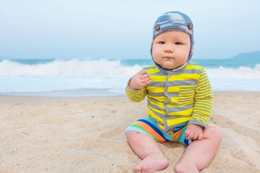 Cute baby sitting on a sand