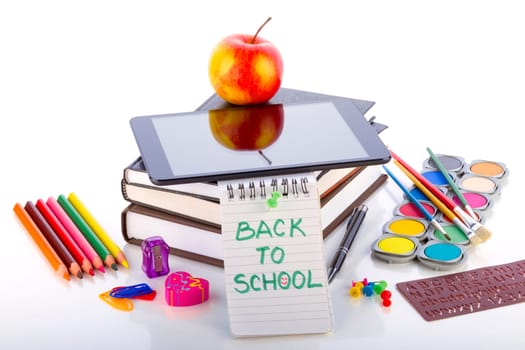 Tablet pc with school and office supplies. Concept of online education.