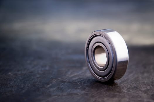 Product holder of a single ball bearing on slate  very shallow depth of field