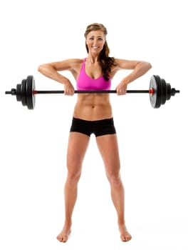 Full length front view of attractive young woman lifting barbell on white background.