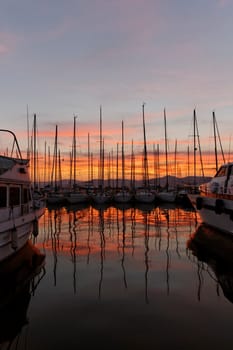 Saint-Tropez,sailing masts with lighthouse in the evening light,Cote d'Azur,Provence,South of France,Europe