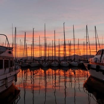 Saint-Tropez,sailing masts with lighthouse in the evening light,Cote d'Azur,Provence,South of France,Europe