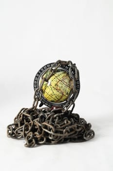 Earth globe close in chain and padlock