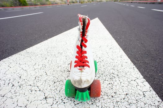 Old Vintage White Skate Boot on the Asphalt Sterret
