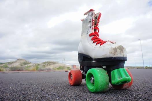 Old Vintage White Skate Boot on the Asphalt Sterret