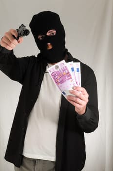 Black Dressed Young Man Holding a Pistol Gun
