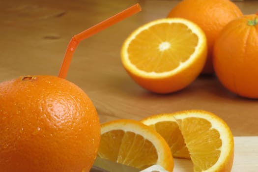 Orange with drinking straw