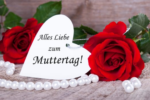 Heart Label with the German Words Alles Liebe zum Muttertag which means Happy Mothers Day and Roses