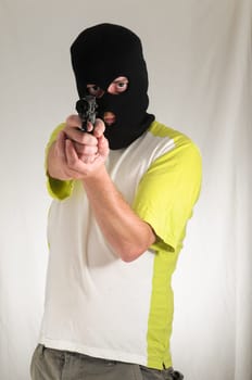 White Dressed Young Man Holding a Pistol Gun