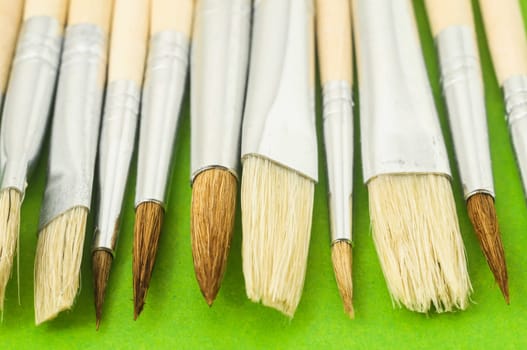 New Wooden Different Paintbrush Set Texture over a Colored Background