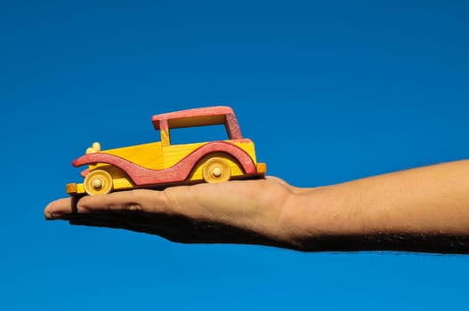Transportation Concept Wooden Toy Car on the Hand
