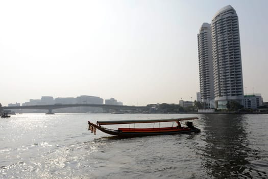 A traditional wooden boat on the Mae Nam Chao Phraya River in the capital Bangkok of Thailand in South East Asia.