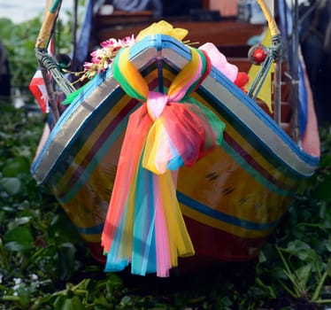 A traditional wooden boat on the Mae Nam Chao Phraya River in the capital Bangkok of Thailand in South East Asia.