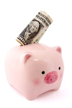 Piggy bank with one dollar bill isolated on white background