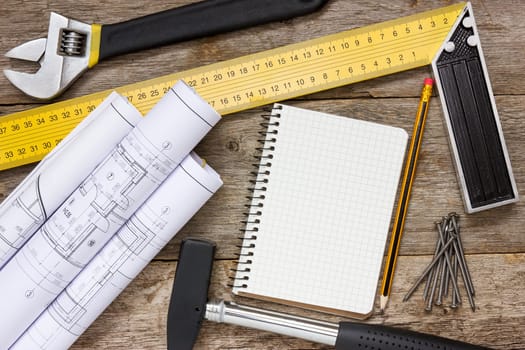 Twisted technical drawing and tools with blank notebook for your text