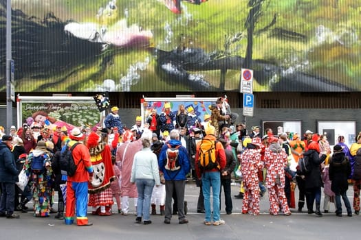 Cologne,Germany – March 02,2014: Colourfully dressed people wearing masks and costumes await the carnival procession on March 2,2014 in Cologne.
