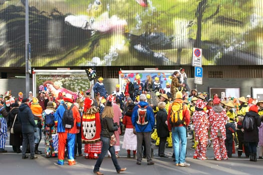 Cologne,Germany – March 02,2014: Colourfully dressed people wearing masks and costumes await the carnival procession on March 2,2014 in Cologne.