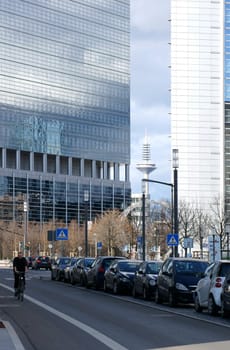 Frankfurt,Germany - February 19,2014: A cyclist rides on a bicycle path in downtown Frankfurt on February 19,2014 in Frankfurt. In the background is the Europaturm.