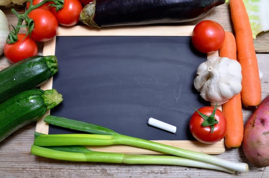Table of fresh vegetables on wooden board