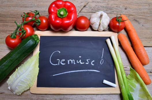 Table of fresh vegetables on wooden board