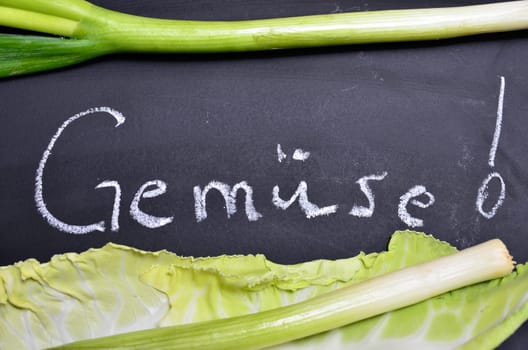 Table of fresh vegetables on wooden board