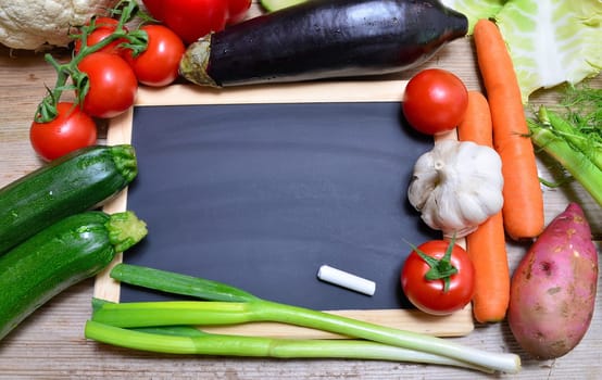 Table of fresh vegetables on wooden board