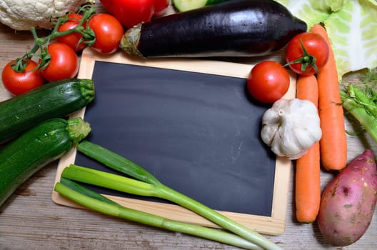 Table of fresh vegetables on wooden board
