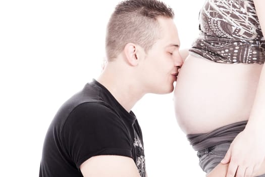 Happy young pregnant couple in the studio