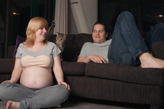 Young couple is waiting for their first child in the living room