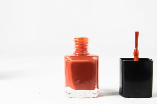 Colorful nail polish brush over white background