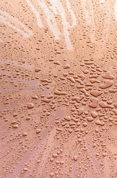 Visible cluster of big drops in gold metal sheet,abstract backgroud,texture.
