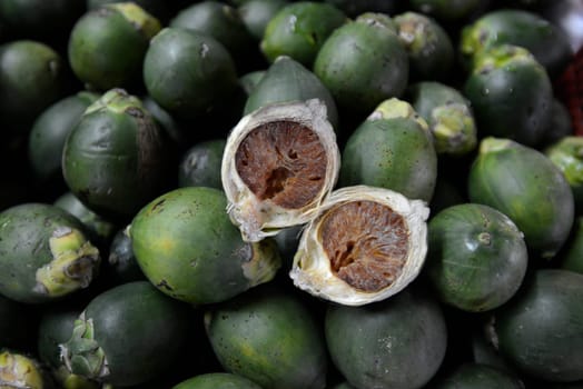 Begging nut at the market of Amnat Charoen in the province of Amnat Charoen northwest of Ubon Ratchathani in northeastern Thailand in South East Asia.