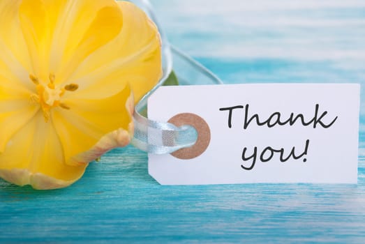 Banner with Thank You on turquoisen Wood with Yellow Tulip Blossom